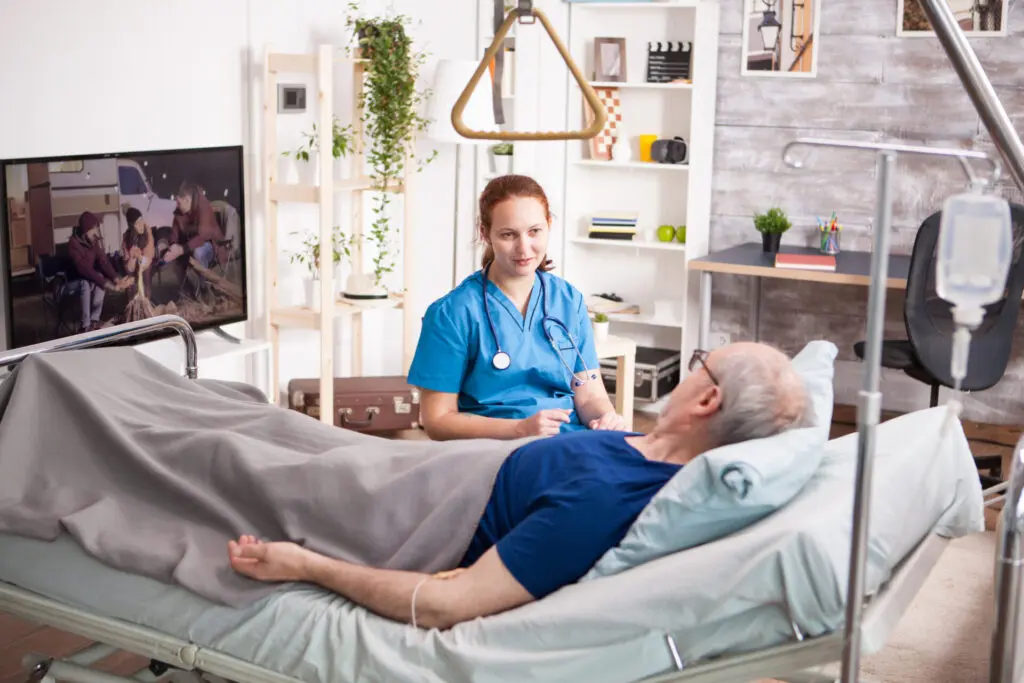 female doctor with stethoscope sharing comfort old man nursing home